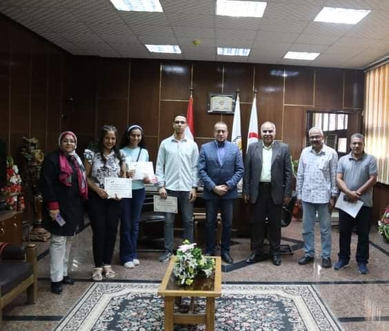 The Dean of the College of Medicine meets with the College of Medicine students who won the art competition